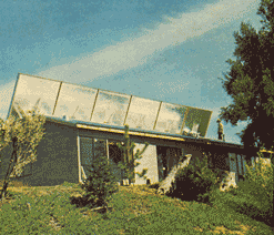 On sunny winter days, the tank's cover is raised as in the photo above to allow the black water containers to absorb energy.